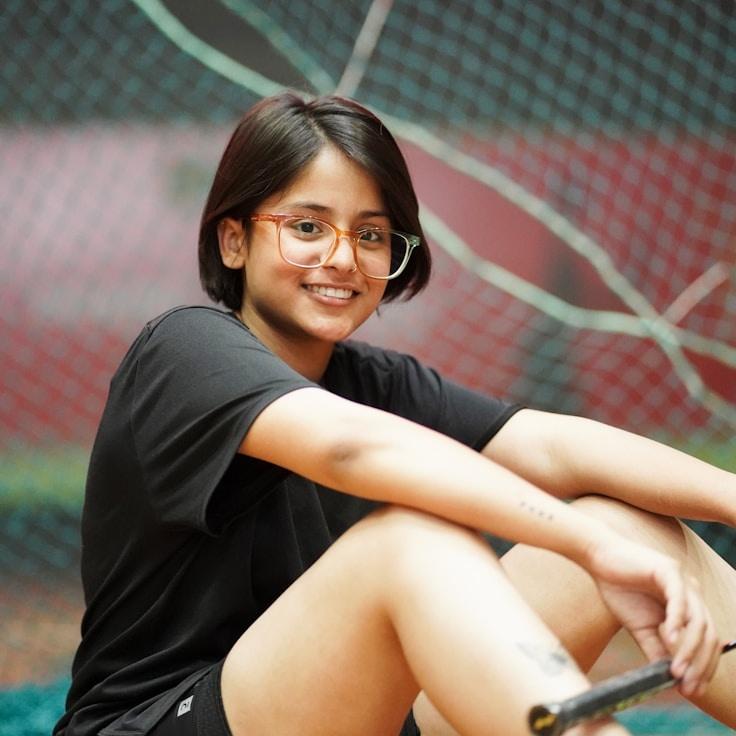 Aanya Patel, Lead Design Curator at Capital Resource Center, reviewing corporate floral arrangements